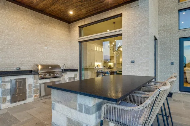 a view of a patio with dining table and chairs