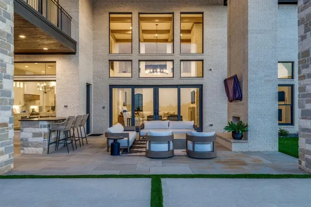 a view of a swimming pool with lounge chairs in front of a house