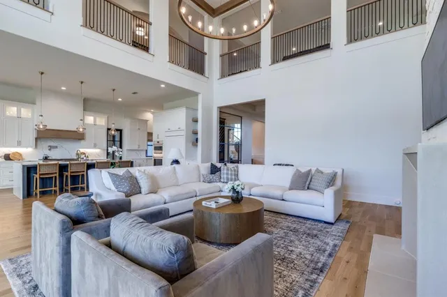a living room with furniture and a view of kitchen