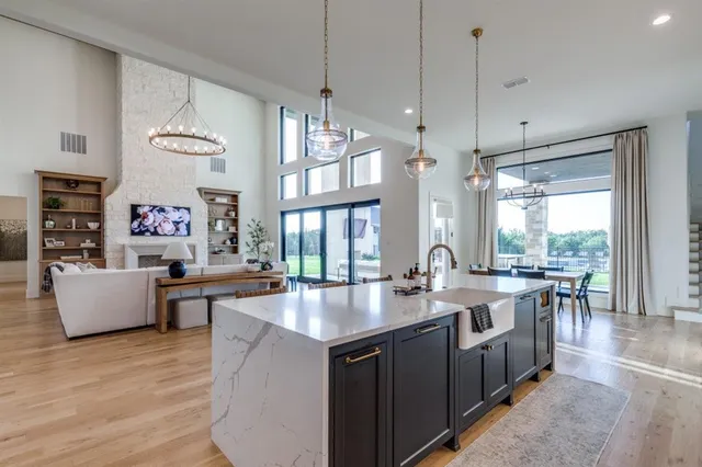 a open kitchen with stainless steel appliances granite countertop a stove and refrigerator