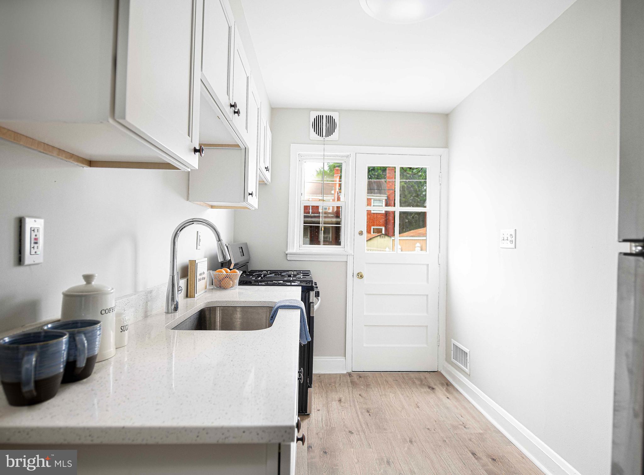 747 Middlesex Road Baltimore, MD 21221 - Photo 12 of 25 a kitchen with sink and refrigerator