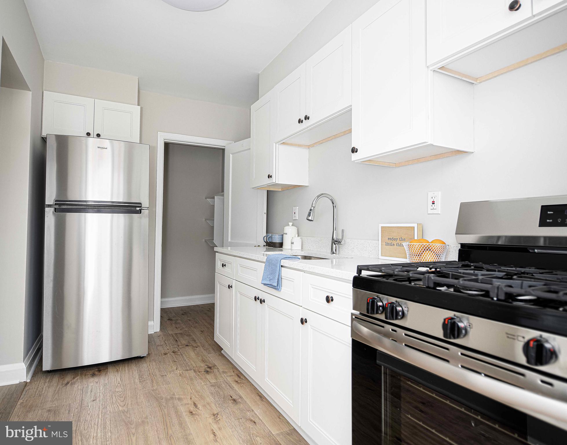 747 Middlesex Road Baltimore, MD 21221 - Photo 13 of 25 a kitchen with wooden cabinets and stainless steel appliances