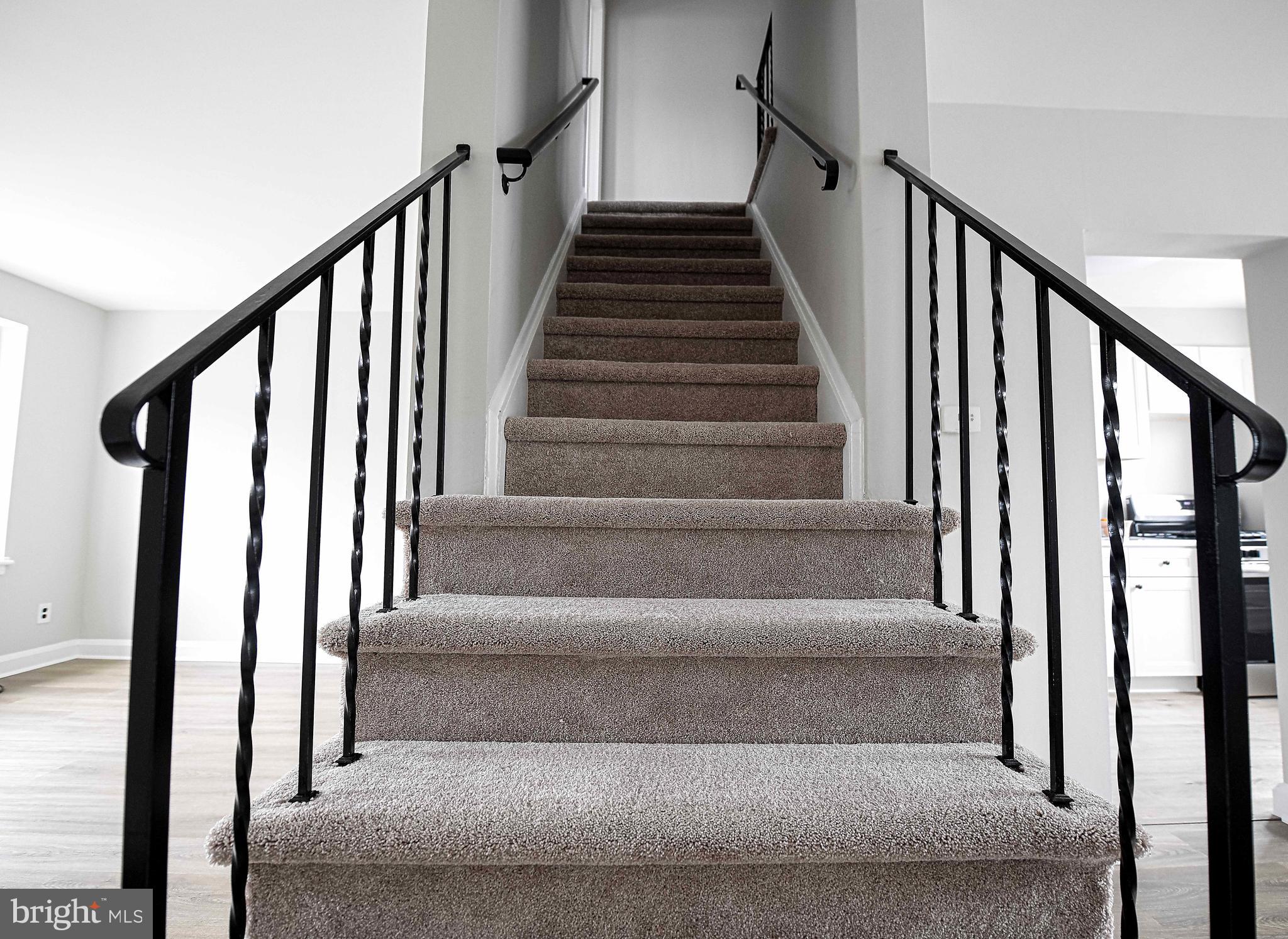 747 Middlesex Road Baltimore, MD 21221 - Photo 15 of 25 a view of staircase with lots of frames on wall