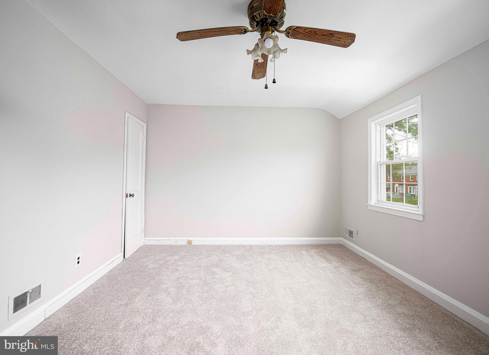 747 Middlesex Road Baltimore, MD 21221 - Photo 16 of 25 an empty room with a window and a fan