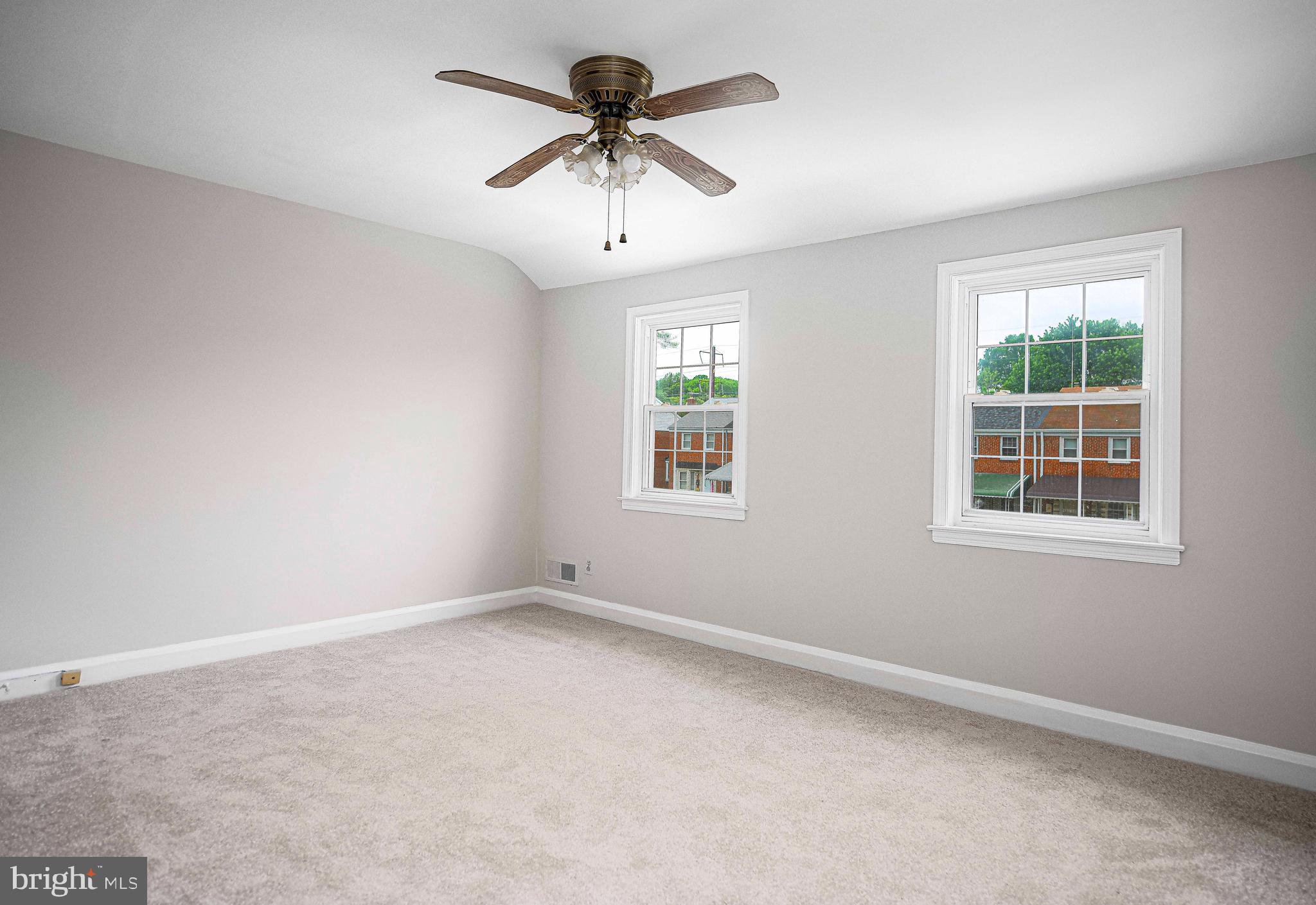 747 Middlesex Road Baltimore, MD 21221 - Photo 17 of 25 an empty room with windows and fan