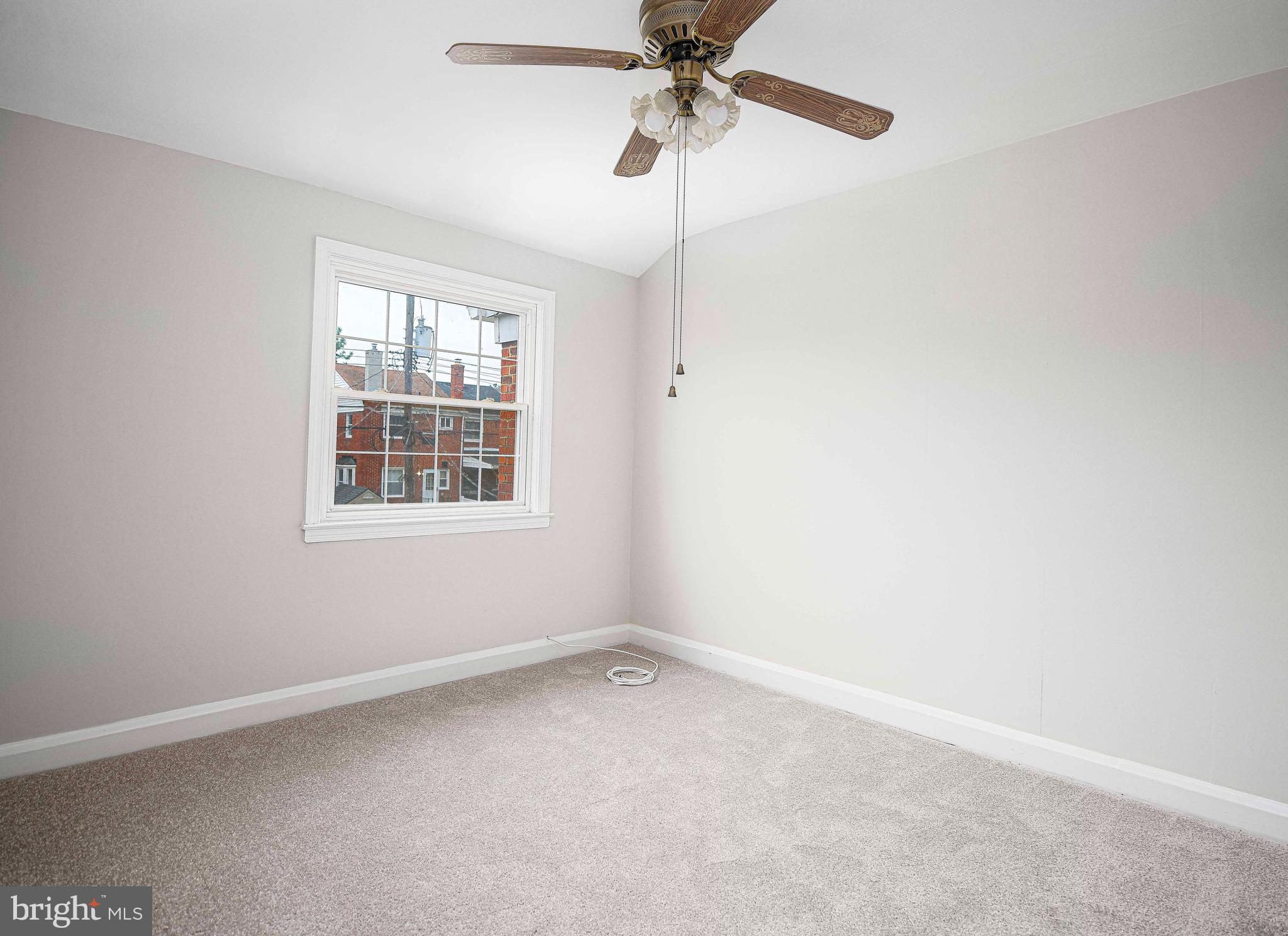 747 Middlesex Road Baltimore, MD 21221 - Photo 20 of 25 an empty room with windows and fan