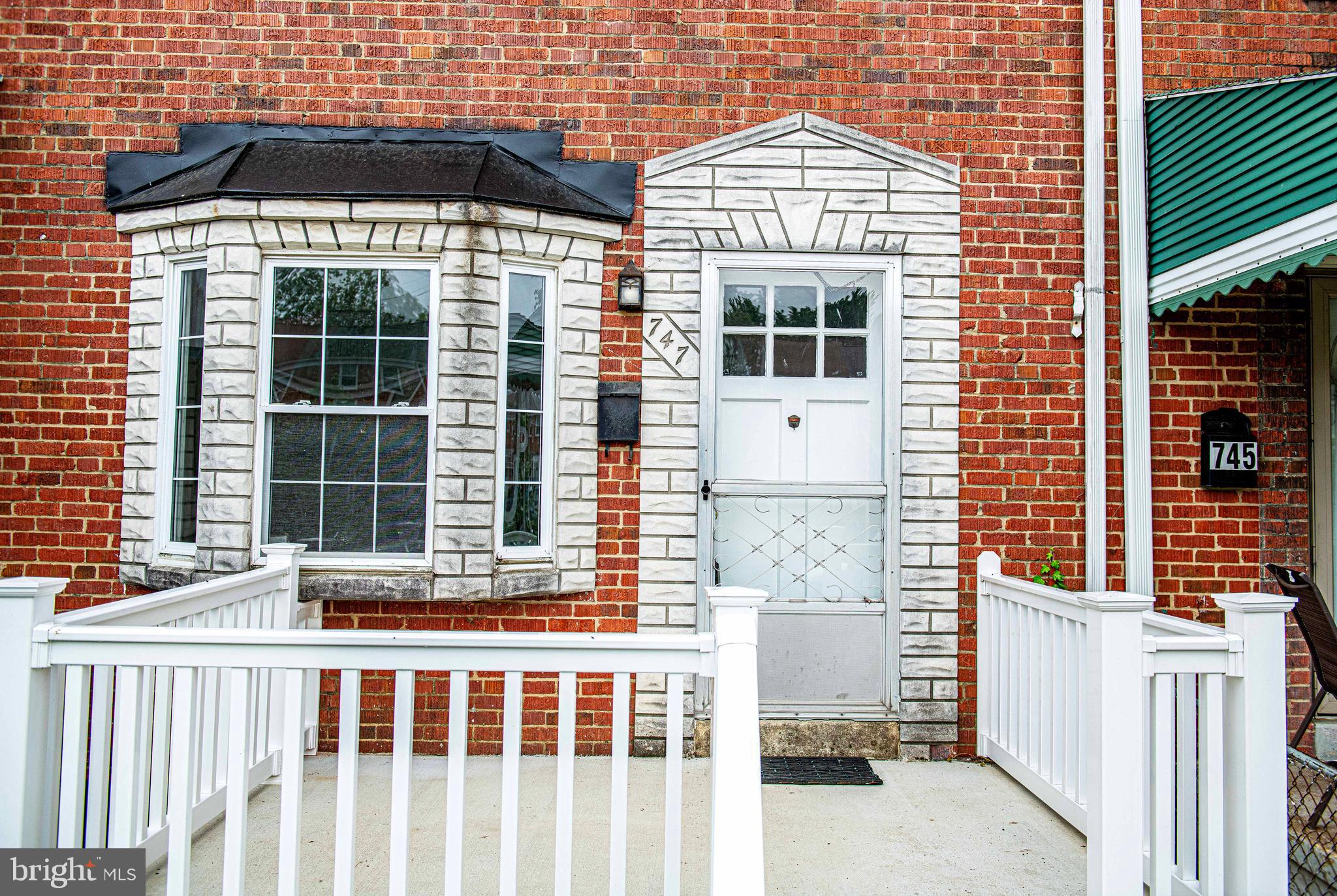 747 Middlesex Road Baltimore, MD 21221 - Photo 3 of 25 a view of a house with a small yard and wooden floor and fence