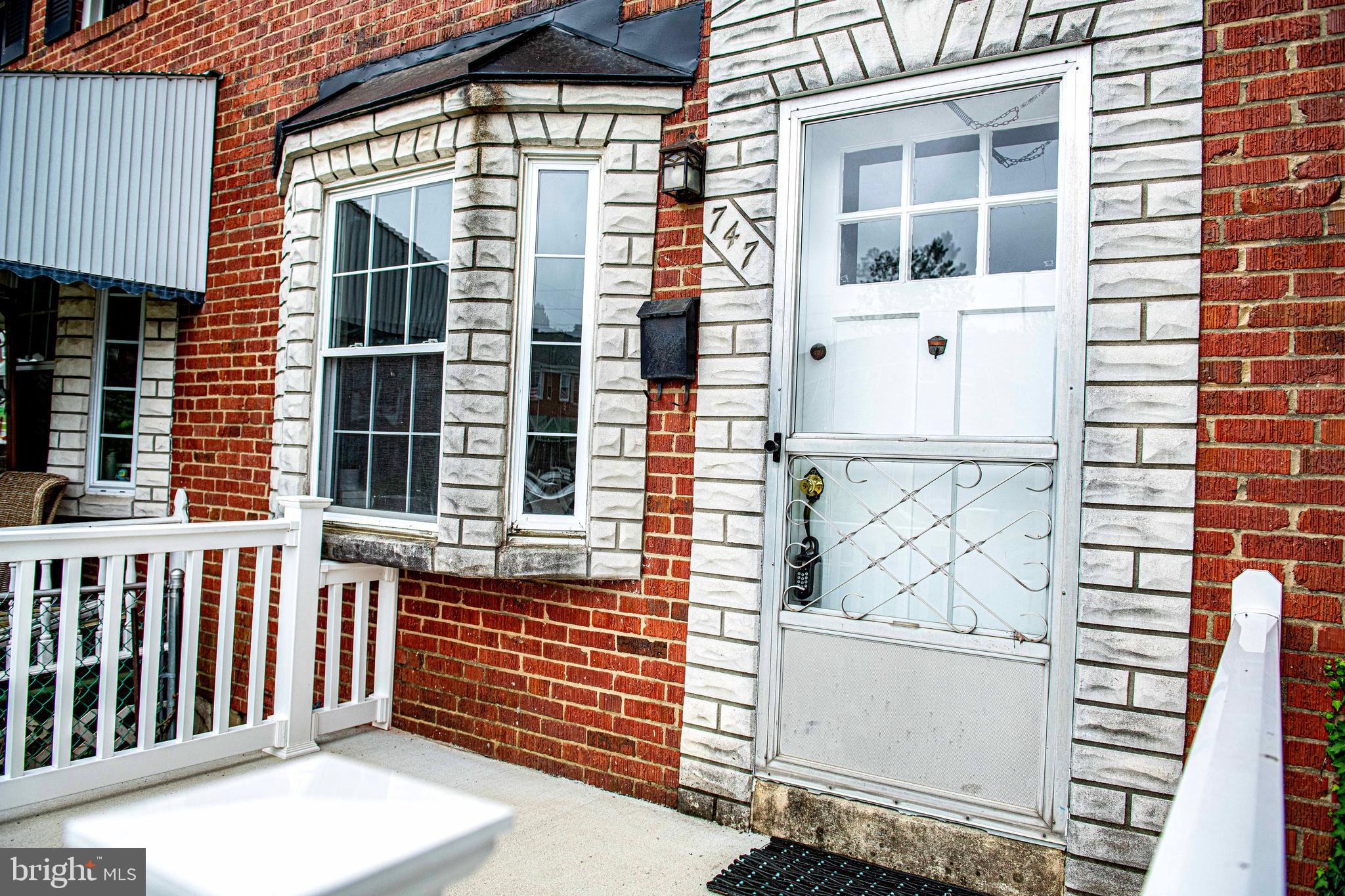 747 Middlesex Road Baltimore, MD 21221 - Photo 4 of 25 a front view of a house with a garage