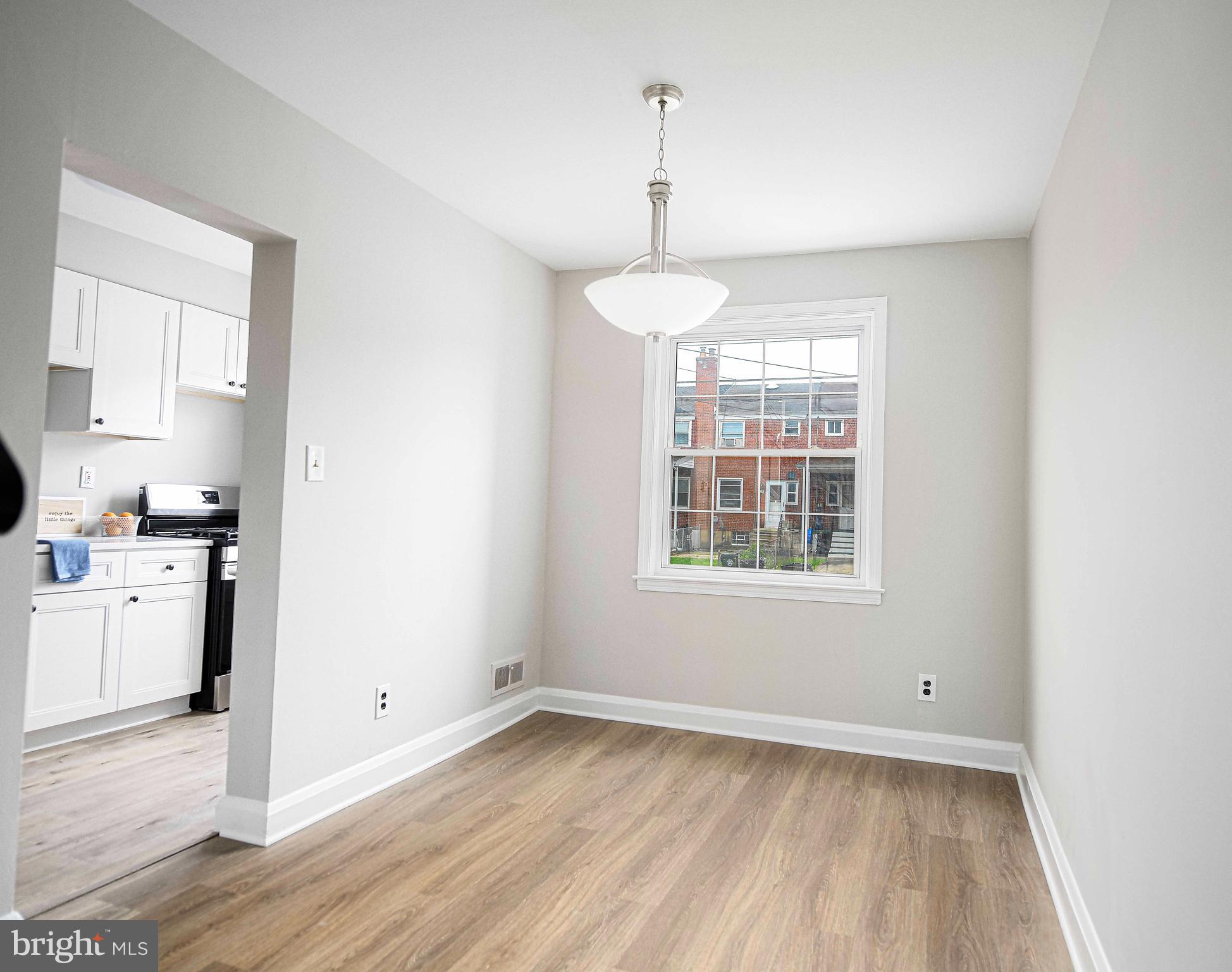 747 Middlesex Road Baltimore, MD 21221 - Photo 9 of 25 a view of a kitchen with a sink dishwasher and wooden floor