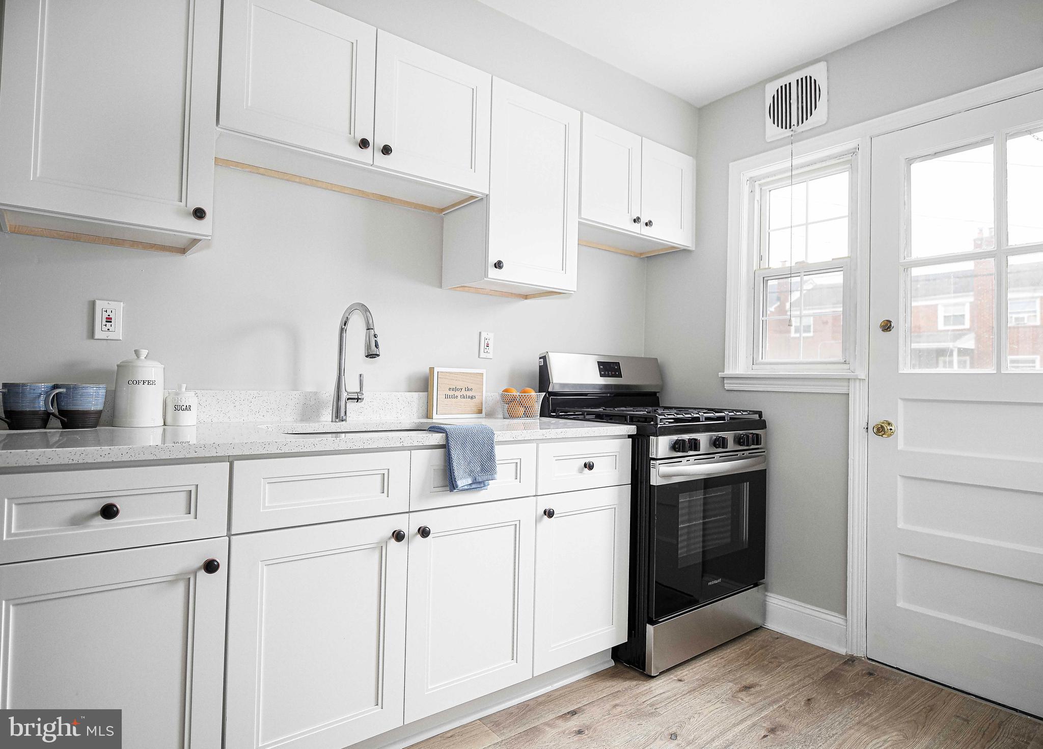 747 Middlesex Road Baltimore, MD 21221 - Photo 10 of 25 a kitchen with white cabinets and appliances