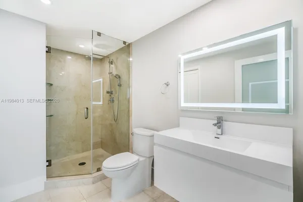 a bathroom with a sink toilet and shower