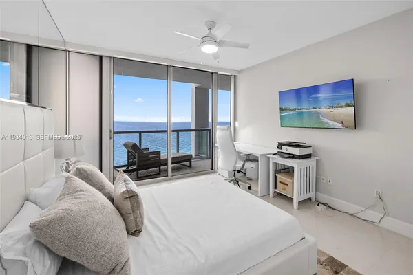 a room with a bed and a flat screen tv