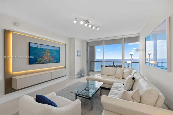 a living room with furniture and a large window