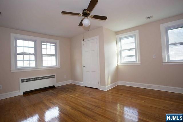 154 Sussex Road Tenafly, NJ 07670 - Photo 10 of 12 wooden floor in an empty room with a window