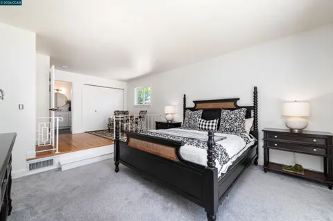 a bedroom with a bed and a lamp