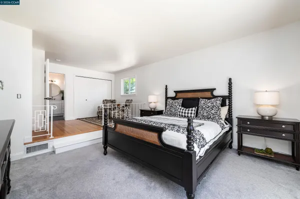 a bedroom with a bed and a lamp