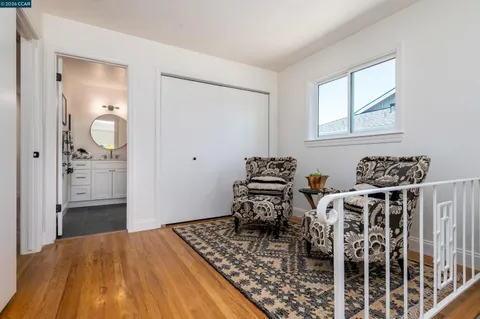 a bed room with furniture and wooden floor