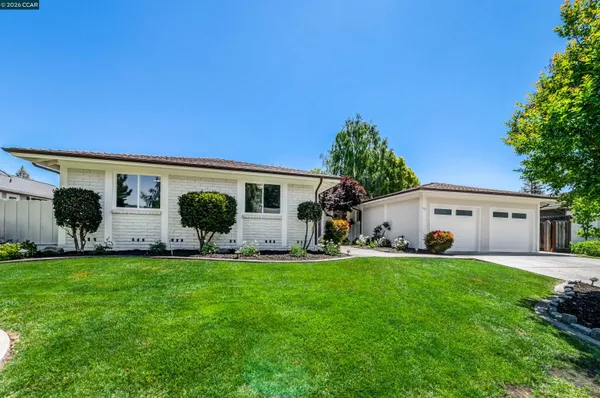 a front view of house with yard and green space