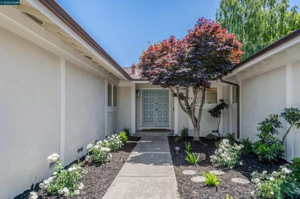 a front view of a house with garden
