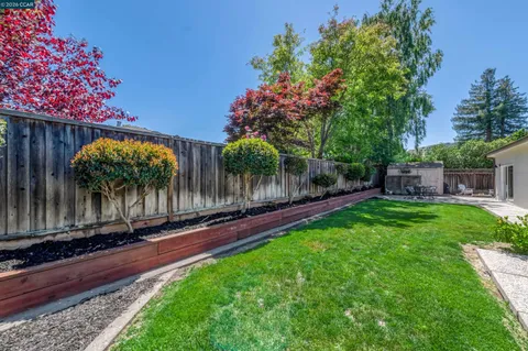 a view of backyard with a table and chairs