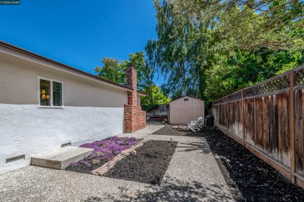 a backyard of a house with table and chairs