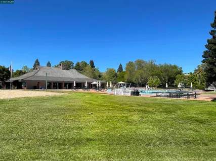 a view of a house with swimming pool and sitting area