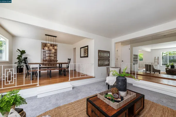 a living room with furniture a rug and a table