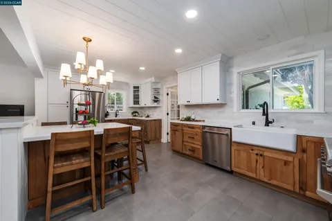 a kitchen that has a lot of cabinets in it and appliances