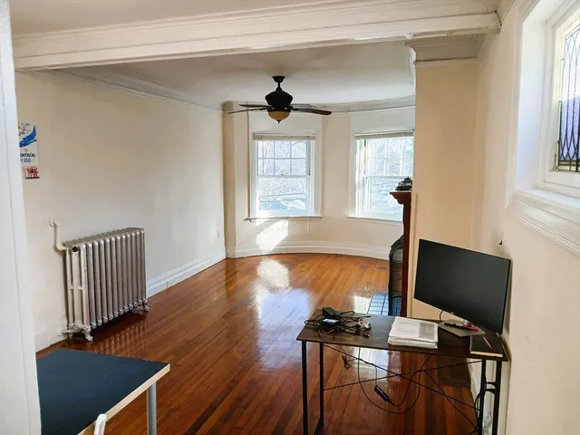 a view of a livingroom with workspace and a window