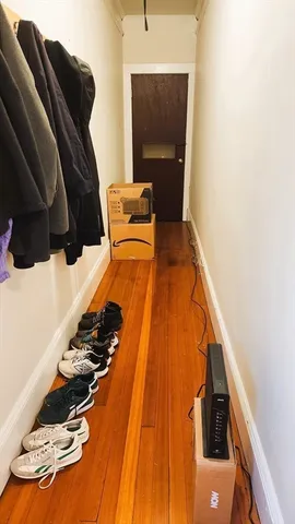 a view of walk in closet with clothes and shoes