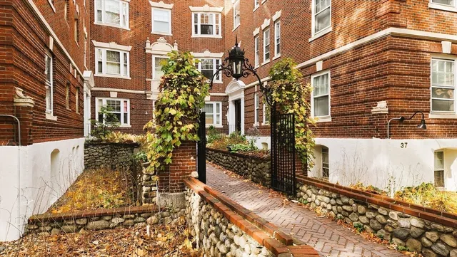 a view of a brick building next to a yard