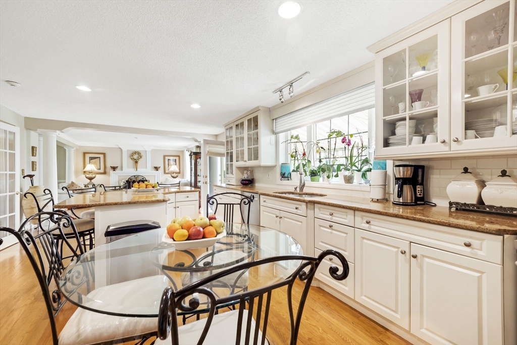 63 Parker Road Shirley, MA 01464 - Photo 10 of 32 a kitchen with stainless steel appliances granite countertop a table and chairs in it