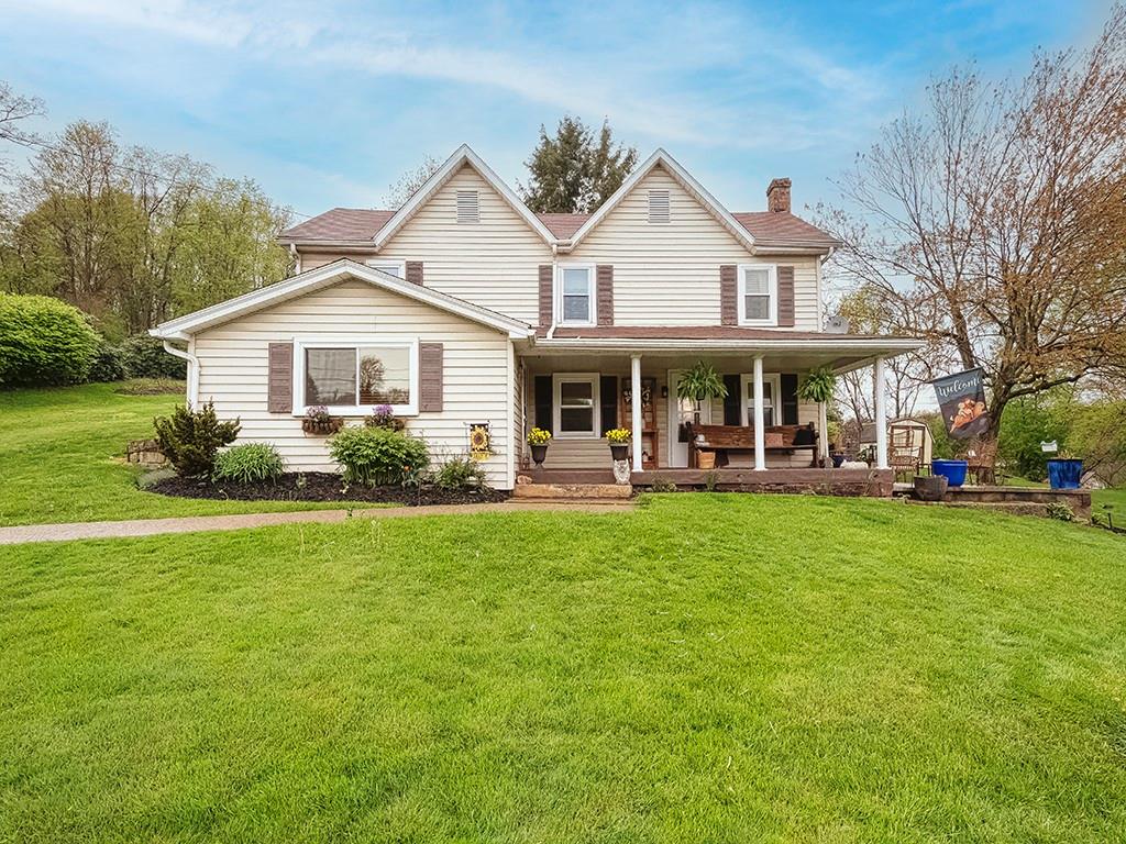 447 Winfield Road Cabot, PA 16023 - Photo 1 of 28 a front view of a house with a yard table and chairs