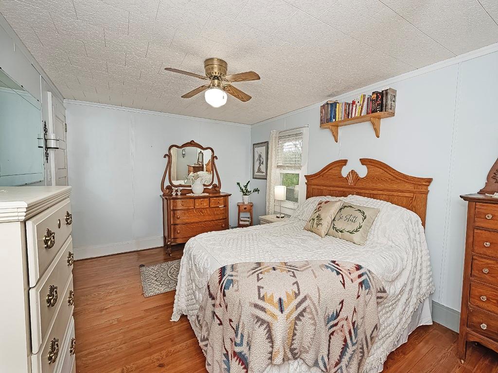 447 Winfield Road Cabot, PA 16023 - Photo 17 of 28 a bedroom with a bed and a chandelier