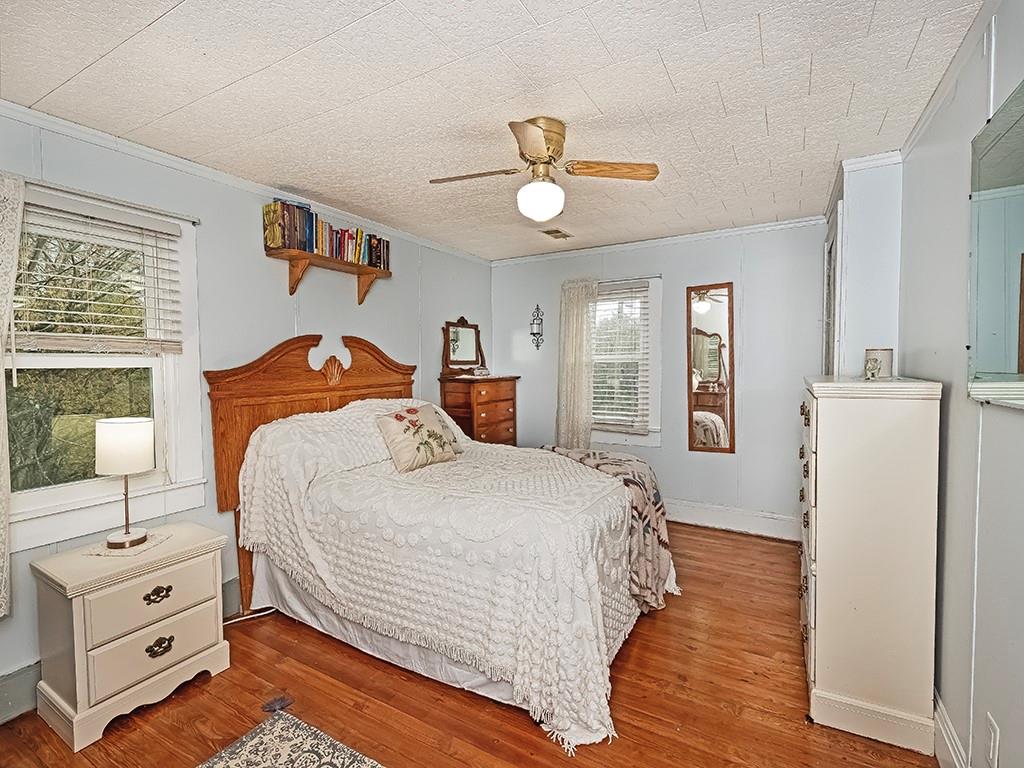 447 Winfield Road Cabot, PA 16023 - Photo 18 of 28 a bedroom with a bed and wooden floor