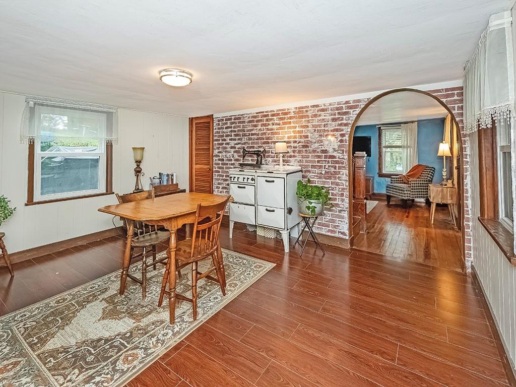 447 Winfield Road Cabot, PA 16023 - Photo 8 of 28 a dining room with wooden floor a glass table and chairs