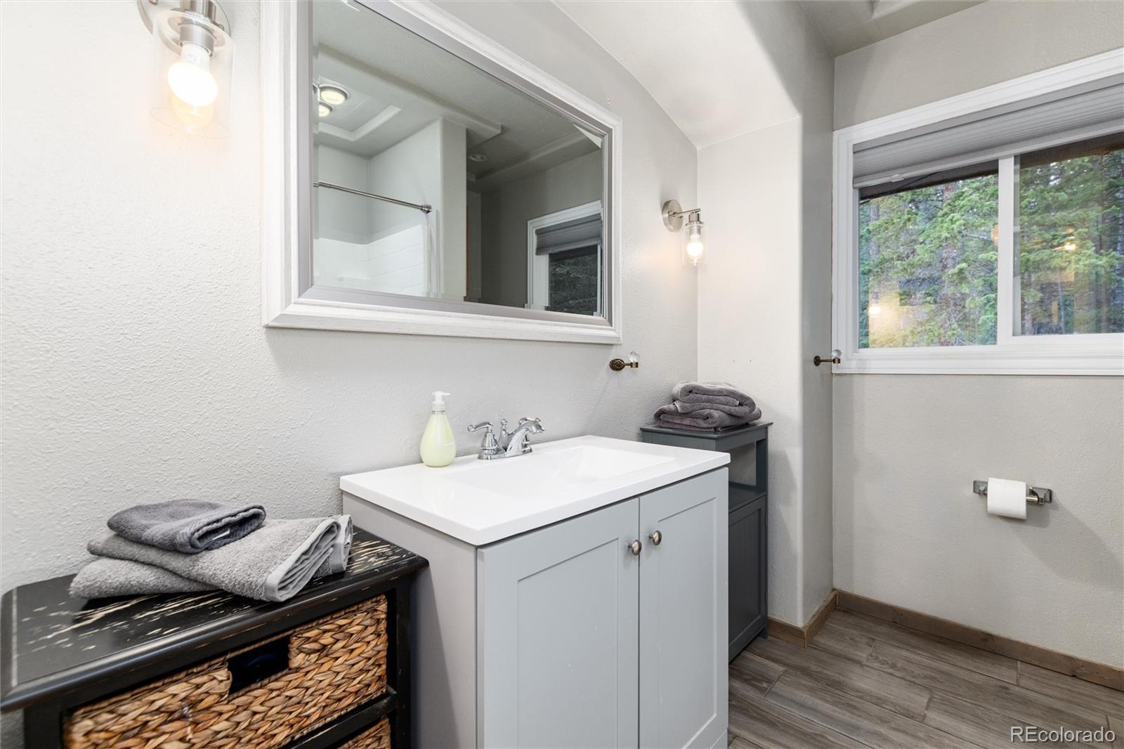 159 Lake Road Idaho Springs, CO 80452 - Photo 15 of 45 a bathroom with a sink and a mirror