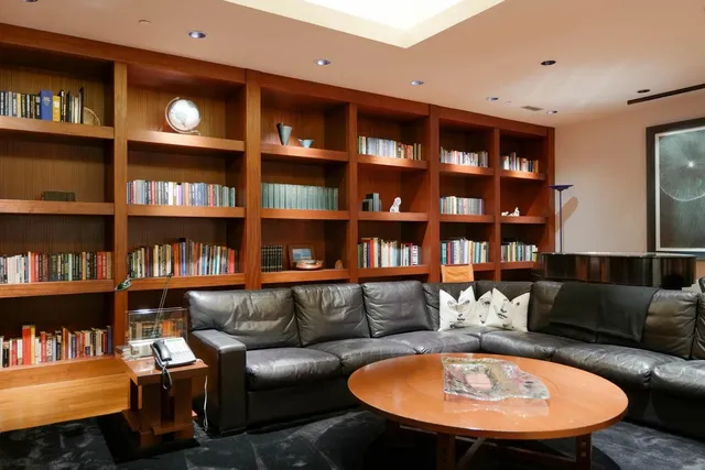 a living room with furniture and a bookshelf