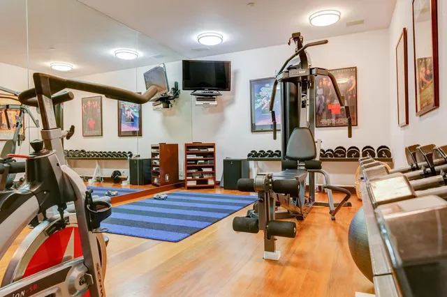 a living room with furniture a flat screen tv and kitchen view