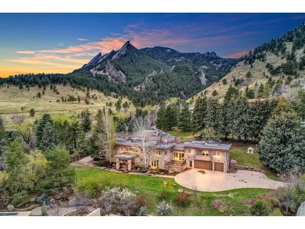a view of a house with a yard and mountain