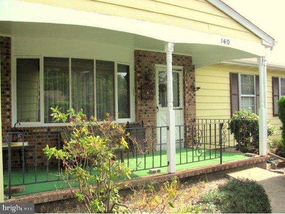 160 Captain Road Manahawkin, NJ 08050 - Photo 1 of 24 a view of a house with a small yard and plants