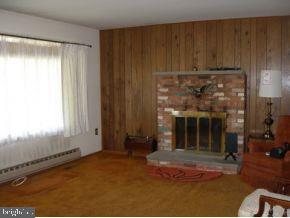 160 Captain Road Manahawkin, NJ 08050 - Photo 6 of 24 a view of an empty room with a fireplace and a window