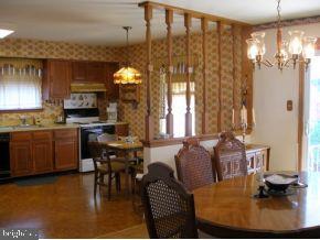 160 Captain Road Manahawkin, NJ 08050 - Photo 9 of 24 a kitchen with sink refrigerator dining table and chairs