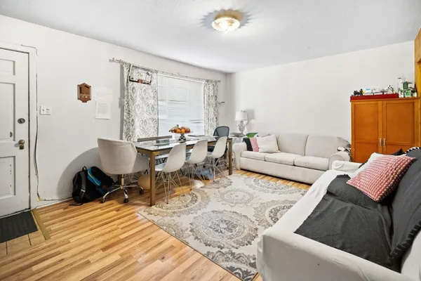 a living room with a couch and a stove next to a window