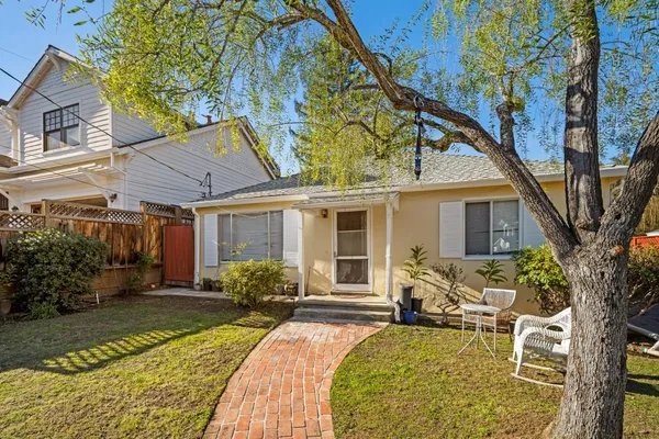a view of a house with backyard porch and sitting area