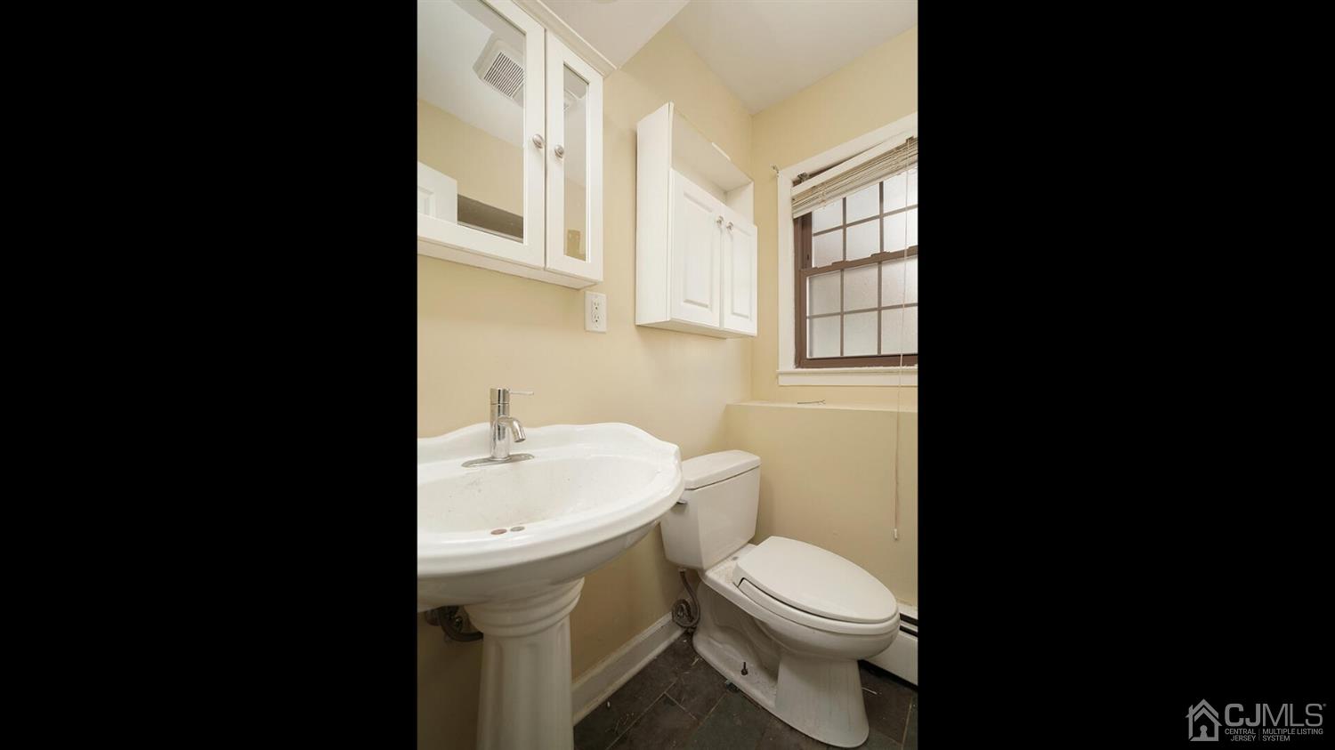 50 Meyer Road Edison, NJ 08817 - Photo 22 of 31 a white toilet sitting next to a bathroom sink