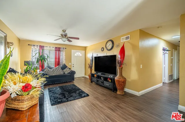a living room with furniture and wooden floor