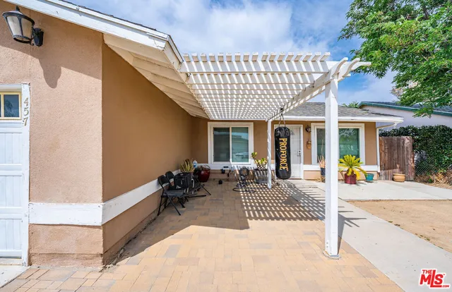 a view of a chair and tables in patio of the house