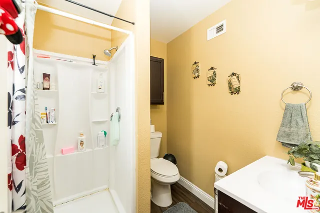 a bathroom with a shower and a curtain