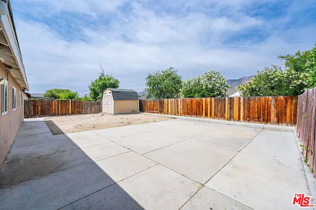 a view of a balcony with many potted plants